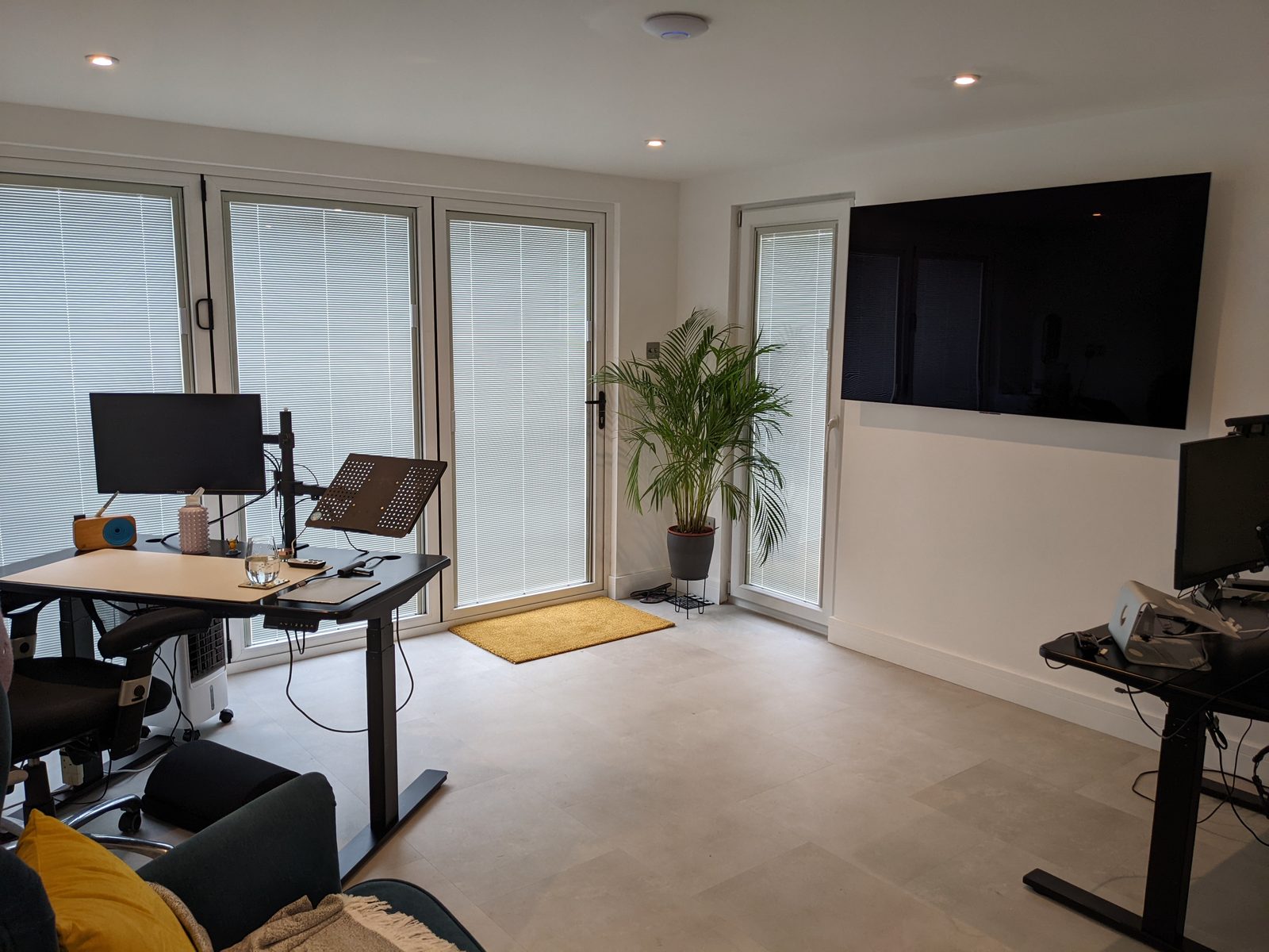 Inside a garden office we built, with a desk, monitor and bi-fold doors