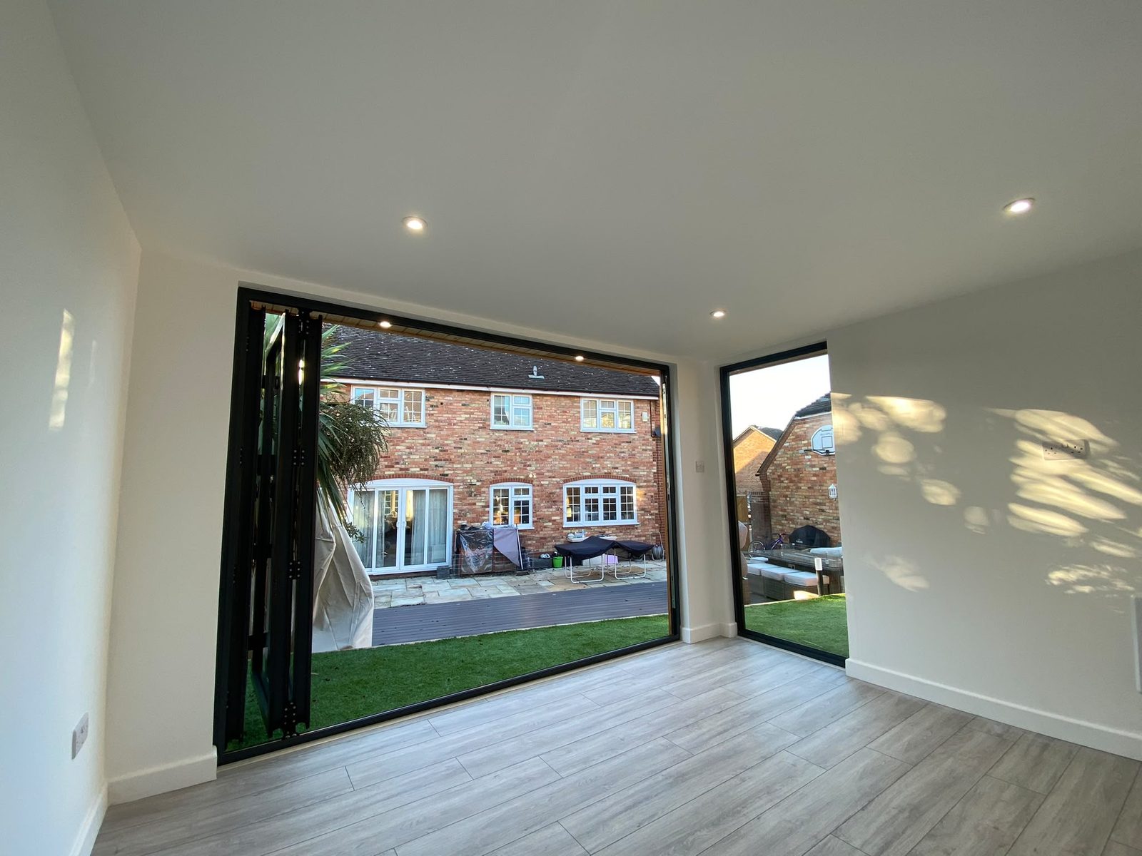 Inside one of our garden rooms, with bi-fold doors open to the garden