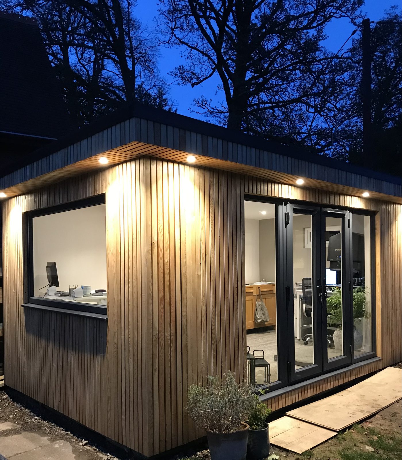 One of our garden rooms at dusk, with the soffit lights on