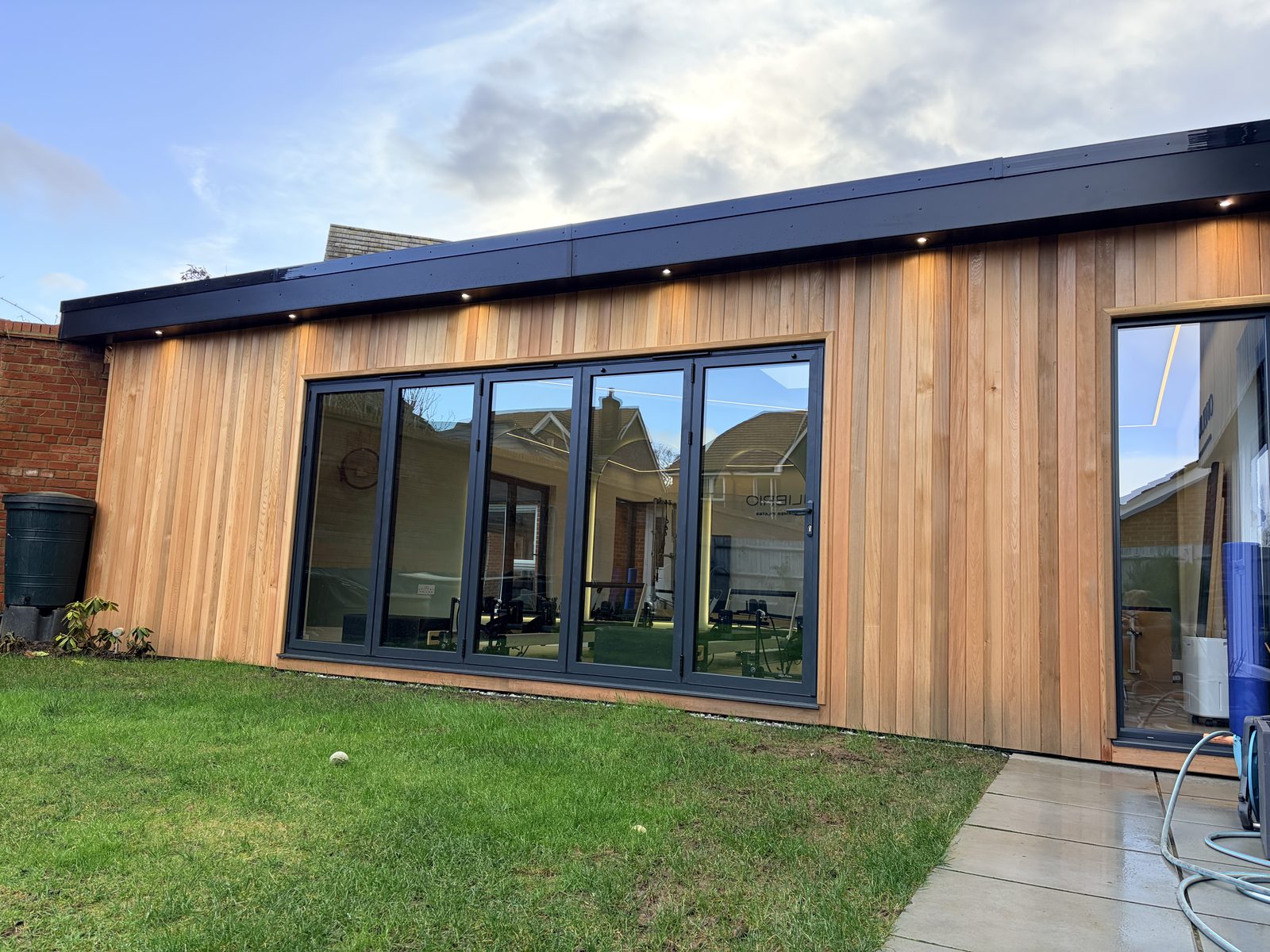 Outside the Pilates studio we built, a cedar-clad building with large glazed doors onto the lawn