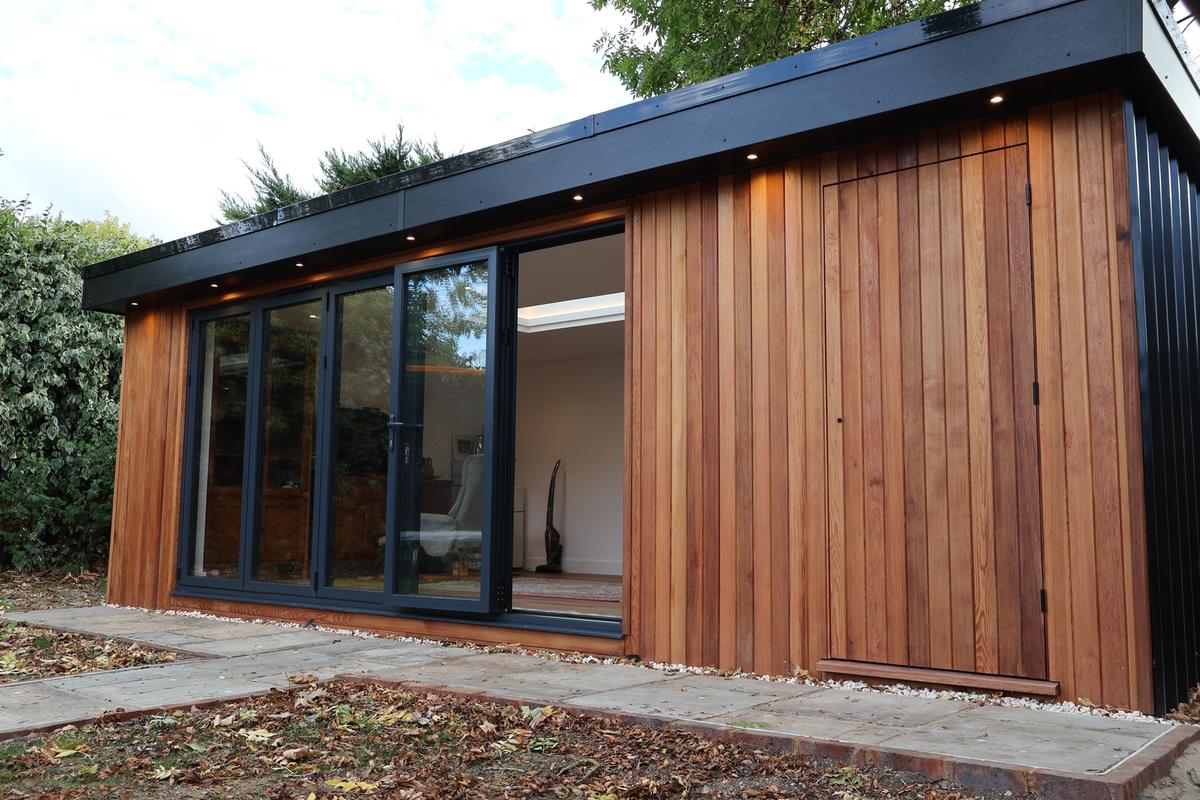 Timber-clad garden office in Windsor with black bi-fold doors and soffit downlights