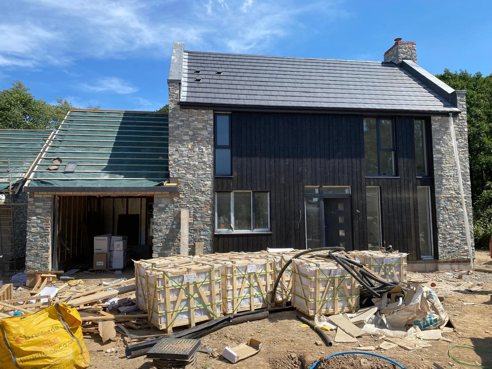Stone and black timber home taking shape