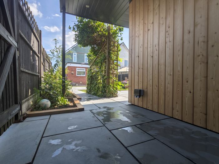 Covered patio beside cedar cladding