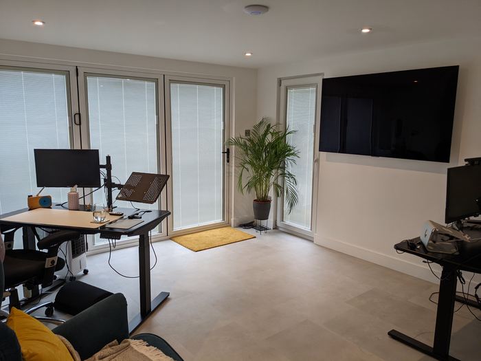 Inside a garden office we built, with a desk, monitor and bi-fold doors