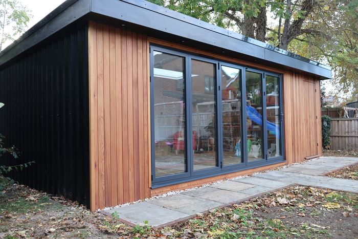 Vertical timber cladding with darker cladding at the side