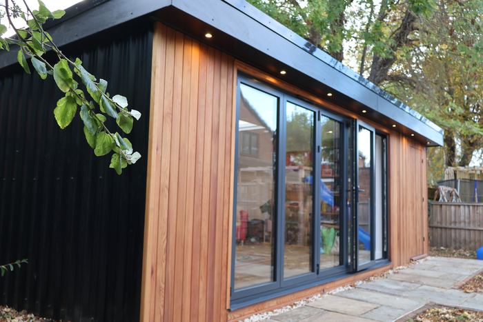 Bi-fold glazing and timber cladding
