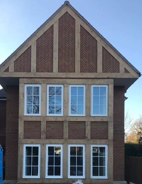 Oak-framed gable with herringbone brick