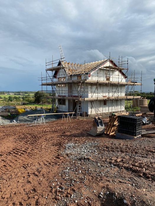 Timber frame and roof trusses going up
